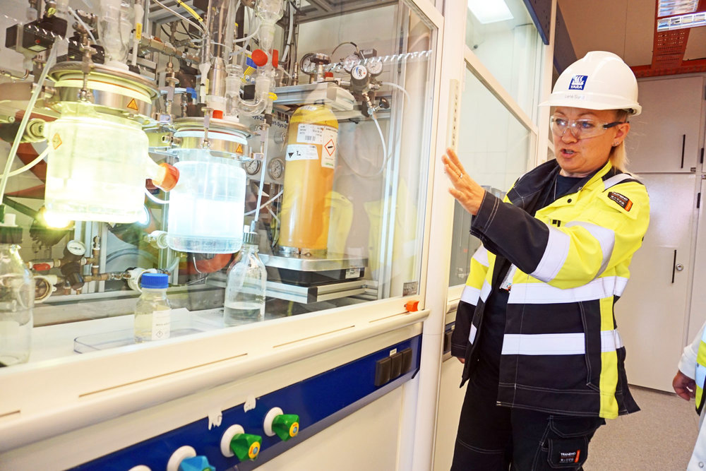 manager of pilot plant shows test rig in a lab-scale