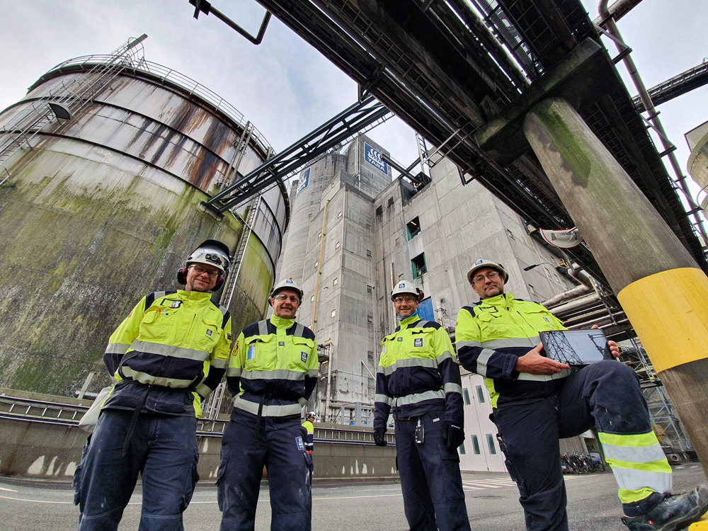 four men standing, posing, industry, outdoors