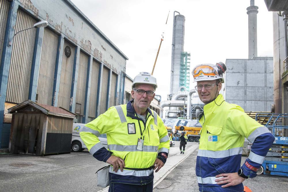 to menn i arbeidsklær, industriområde