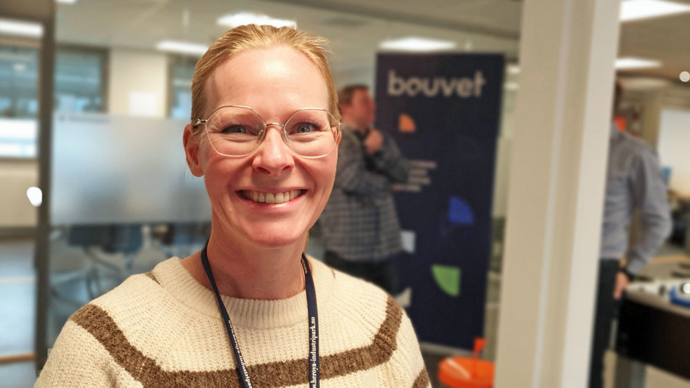 woman wearing glasses standing in office