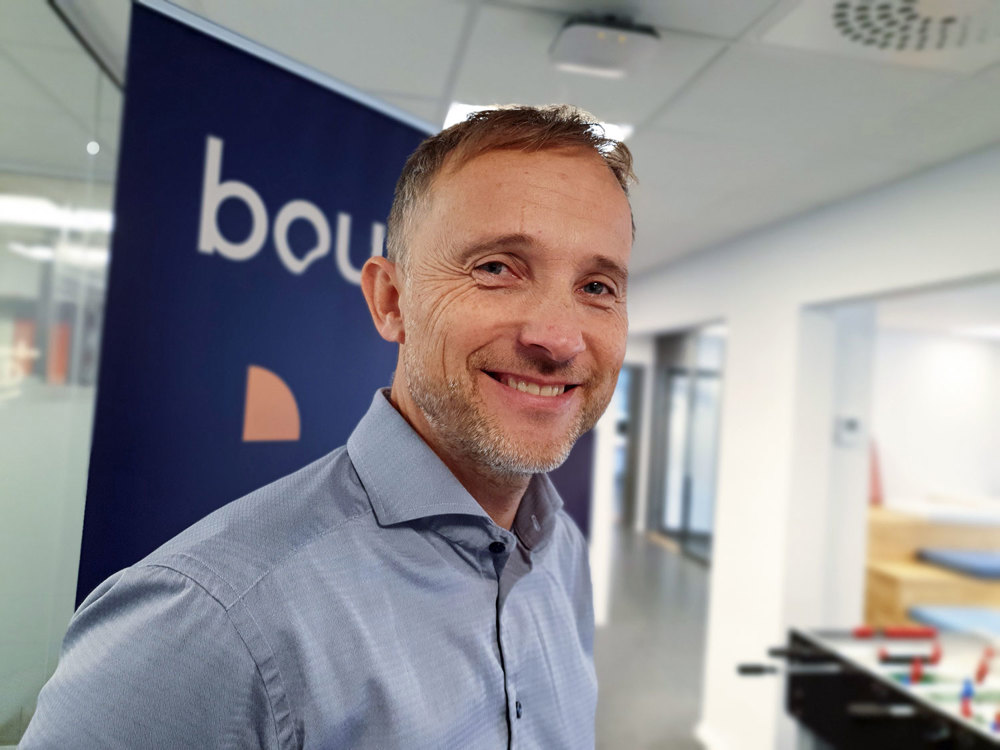 man with beard standing in office space