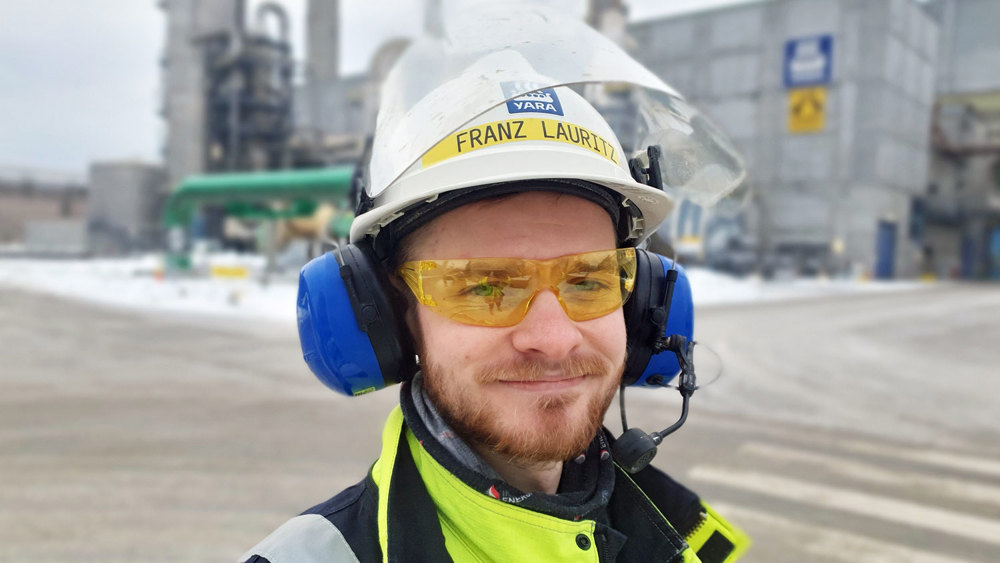 young man, beard, ear protection, white helmet, outdoors, industry