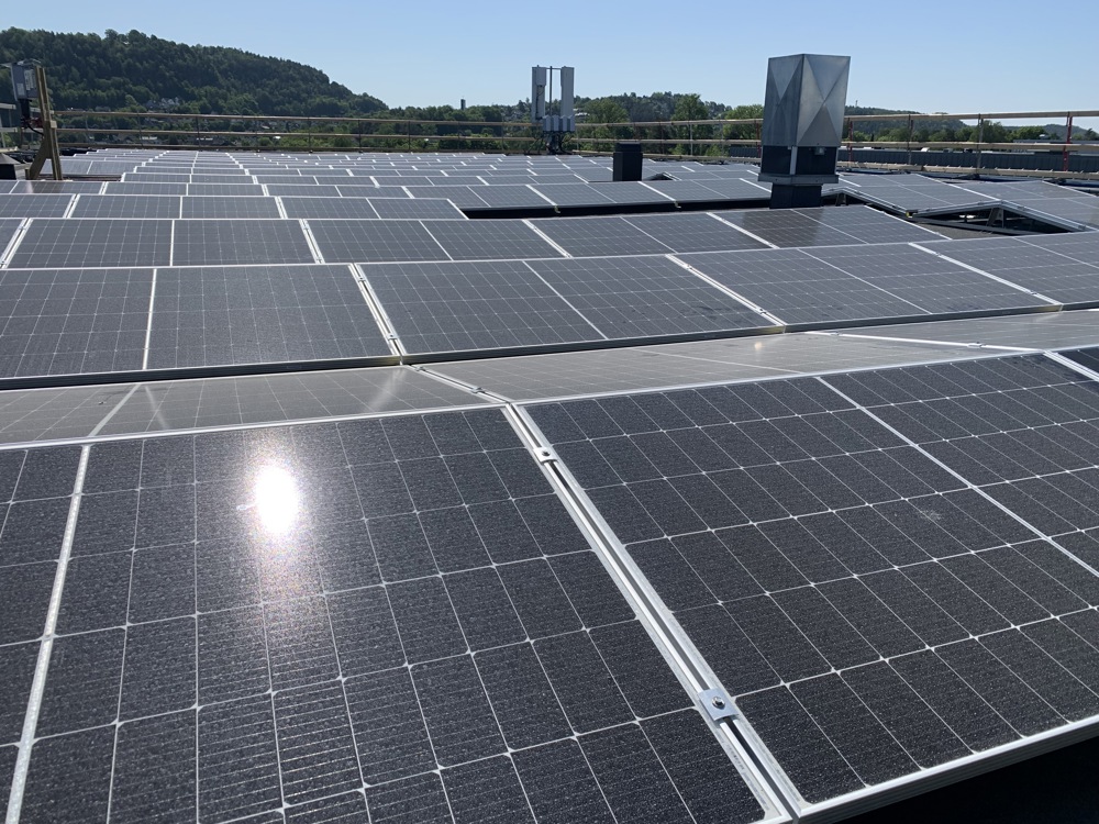 solar panels covering a flat roof on a large building