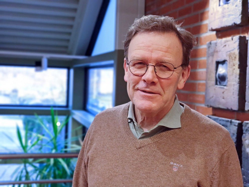 portrait of man, middleaged, glasses, posing, big light room, reception area