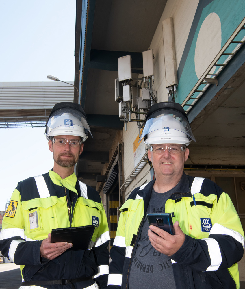 two men measuring 5G coverage with device in their hand