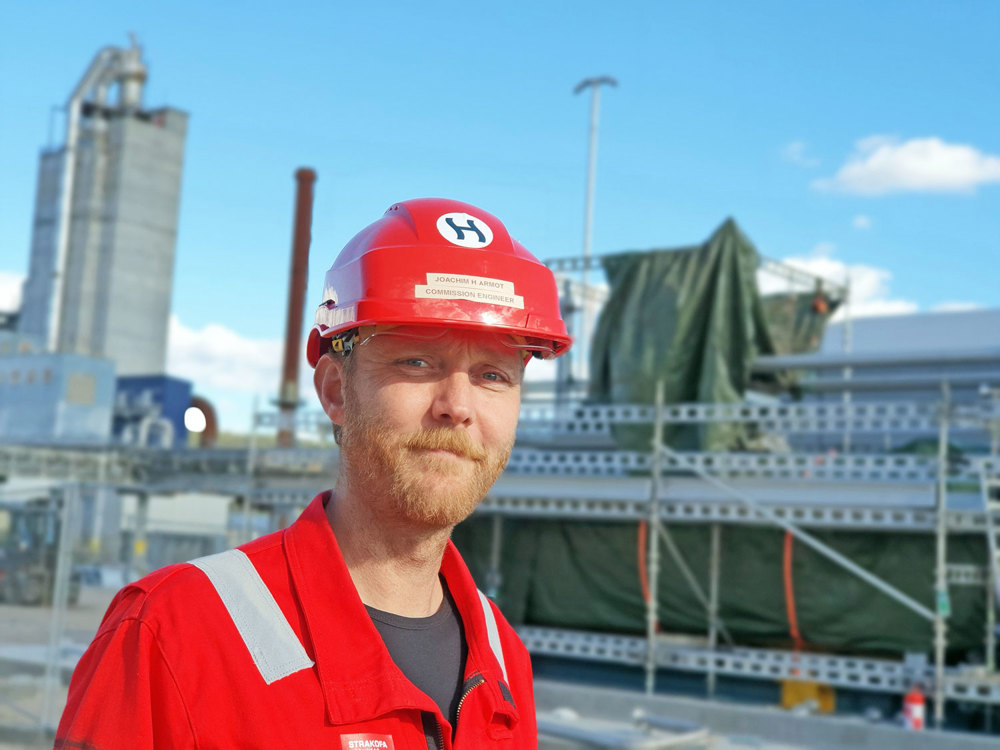 man in red helmet standing by testing site