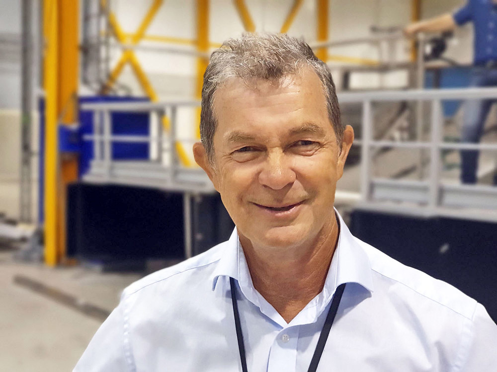 man in pale blue shirt standing in pilot hall