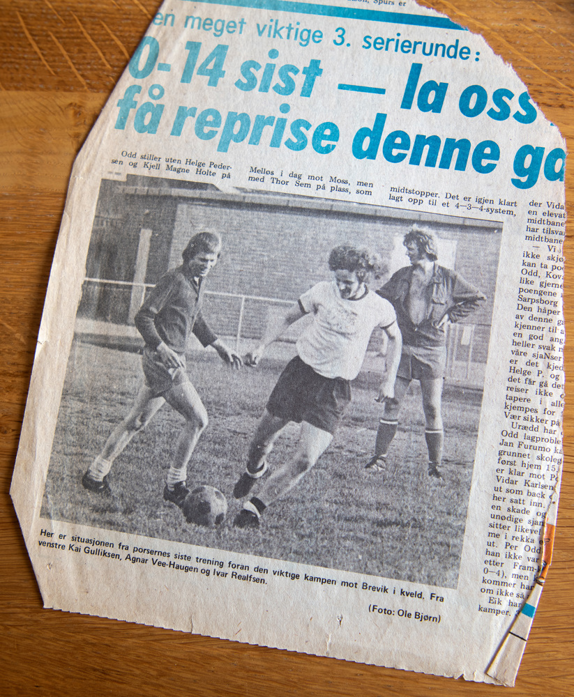 newspaper clipping showing three footballplayers on a field