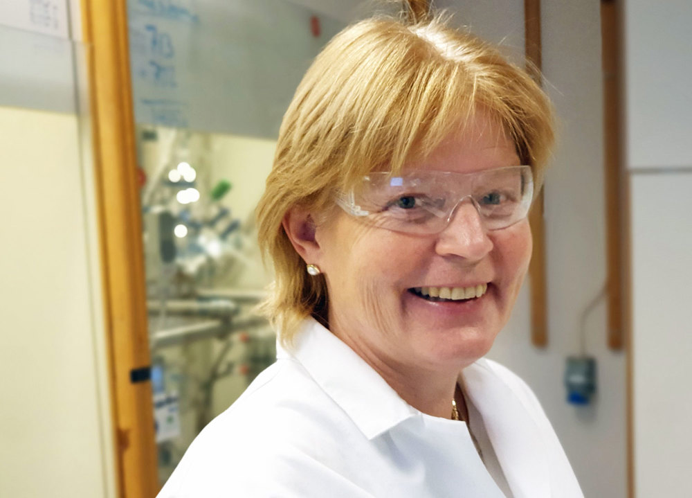 portrait of woman, blond hair, with lab coat