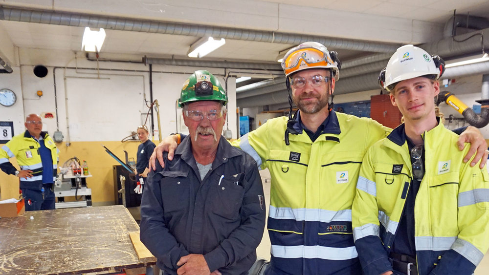 three men of different ages in workshop